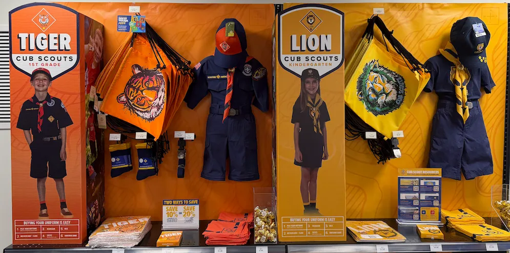 Cub Scout uniforms, neckerchiefs, and handbooks on display at the Tuckahoe Scout Shop.